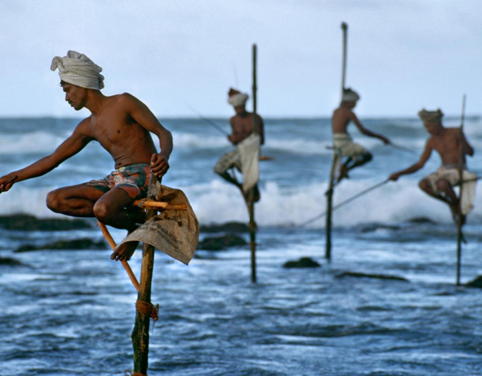 Weligama, South coast, Sri Lanka, 1995."Fishermen along the southern coast of Sri Lanka cast their lines in the traditional way atop poles so they can work in shallow water without disturbing the fish."  - George Eastman HouseThe theatrical stage would not offer a finer gesture, nor a more equisite doubling between the near and the far, than does this picture.  McCurry captures the beauty of a cultural tradition and with it a natural choreography.  This image also preserves a practice now essentially lost to technology, having all but disappeared in the intervening years since the photograph was made.  -Anthony Bannon

Magnum Photos, NYC5948; MCS1995006K200, Phaidon, 55, South Southeast, Iconic Images, final book_iconic